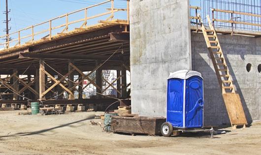 the convenience of on-site restrooms a work site lined with portable toilets